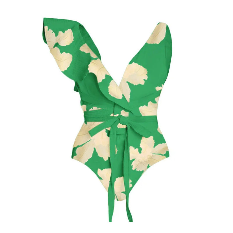 Green and cream floral two-piece swimsuit with a tie-front top and a matching high-waisted wrap skirt.