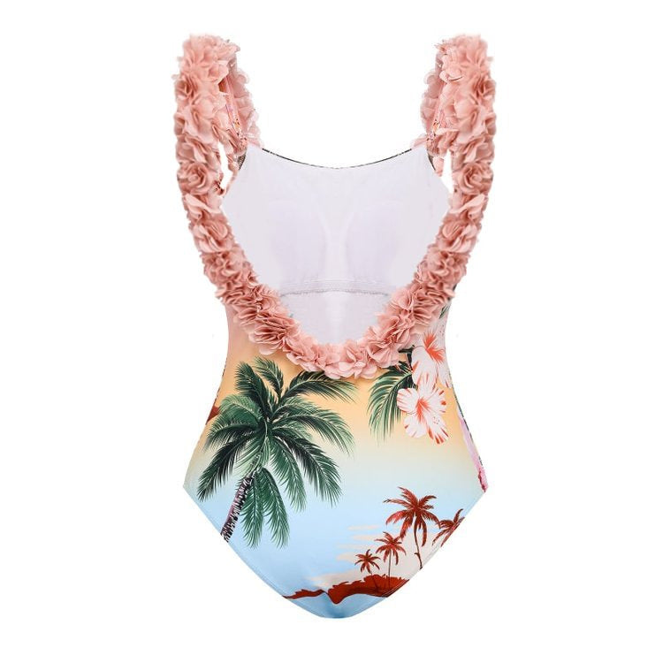 A two-piece ruffled bikini with a palm tree print is paired with a matching sarong