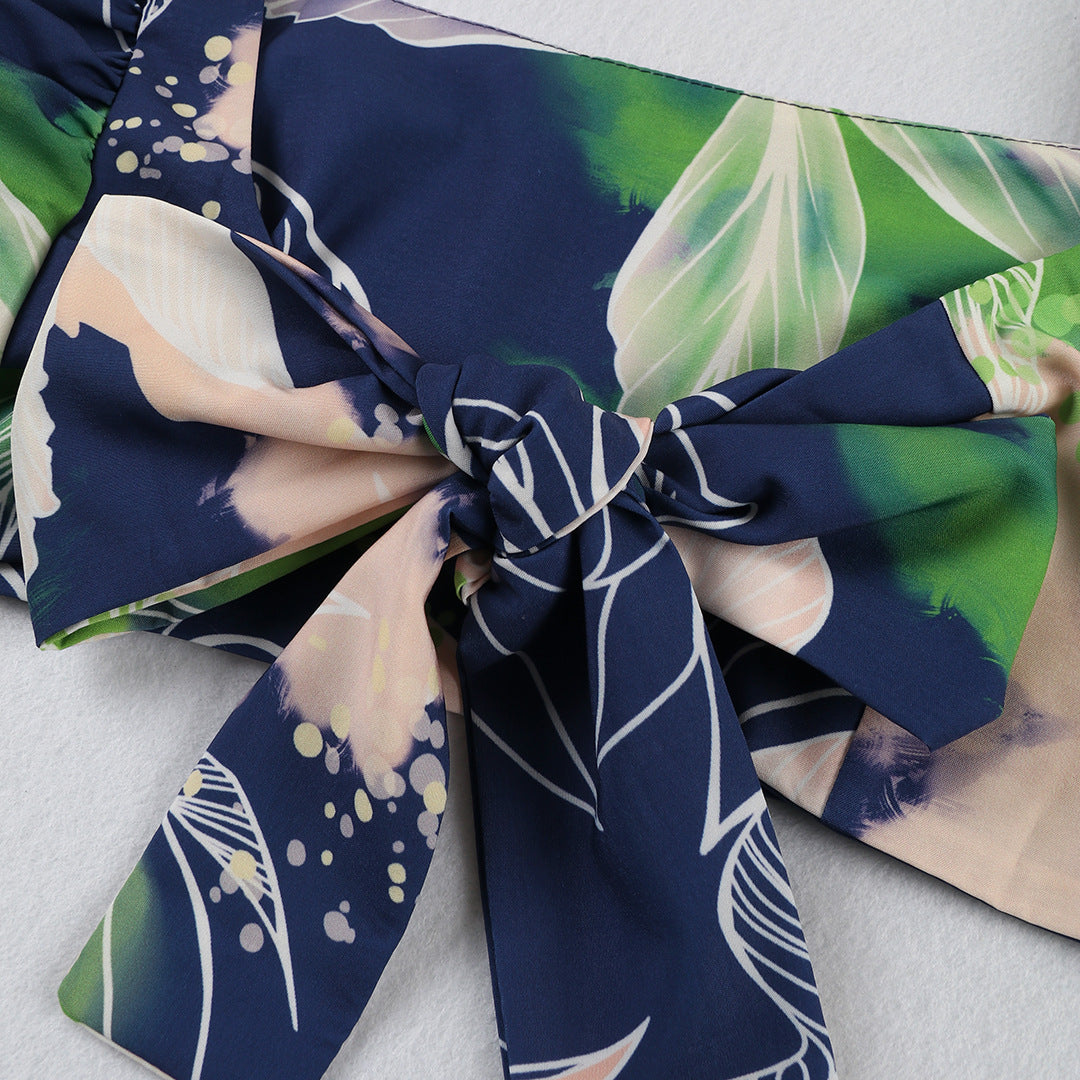 Stylish two-piece outfit consisting of a blue and white floral-print crop top with puff sleeves and a maching tiered maxi skirt.