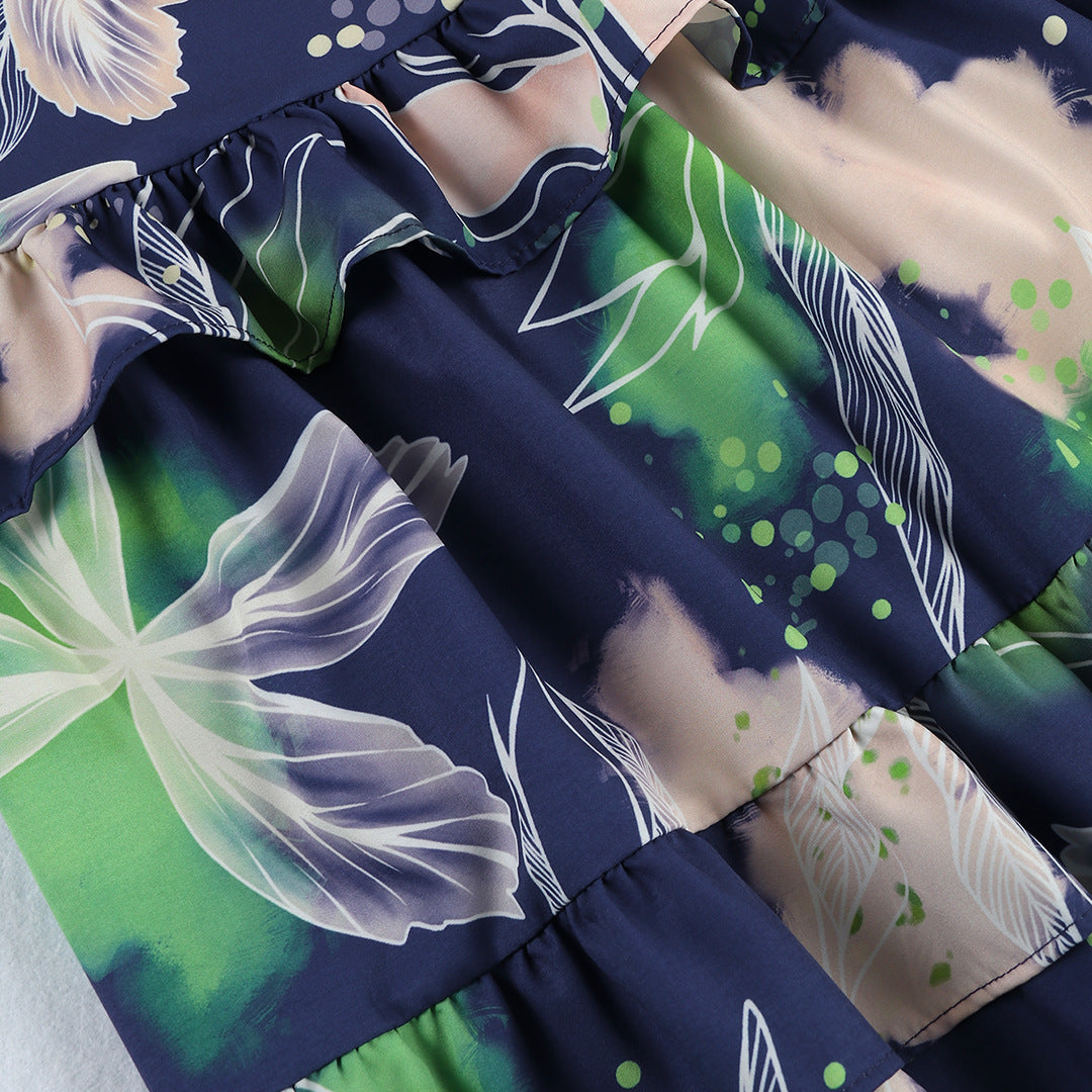 Stylish two-piece outfit consisting of a blue and white floral-print crop top with puff sleeves and a maching tiered maxi skirt.