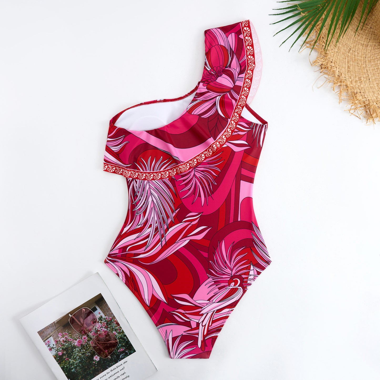 Red one-piece swimsuit with a single ruffled shoulder,paired with a matching short skirt