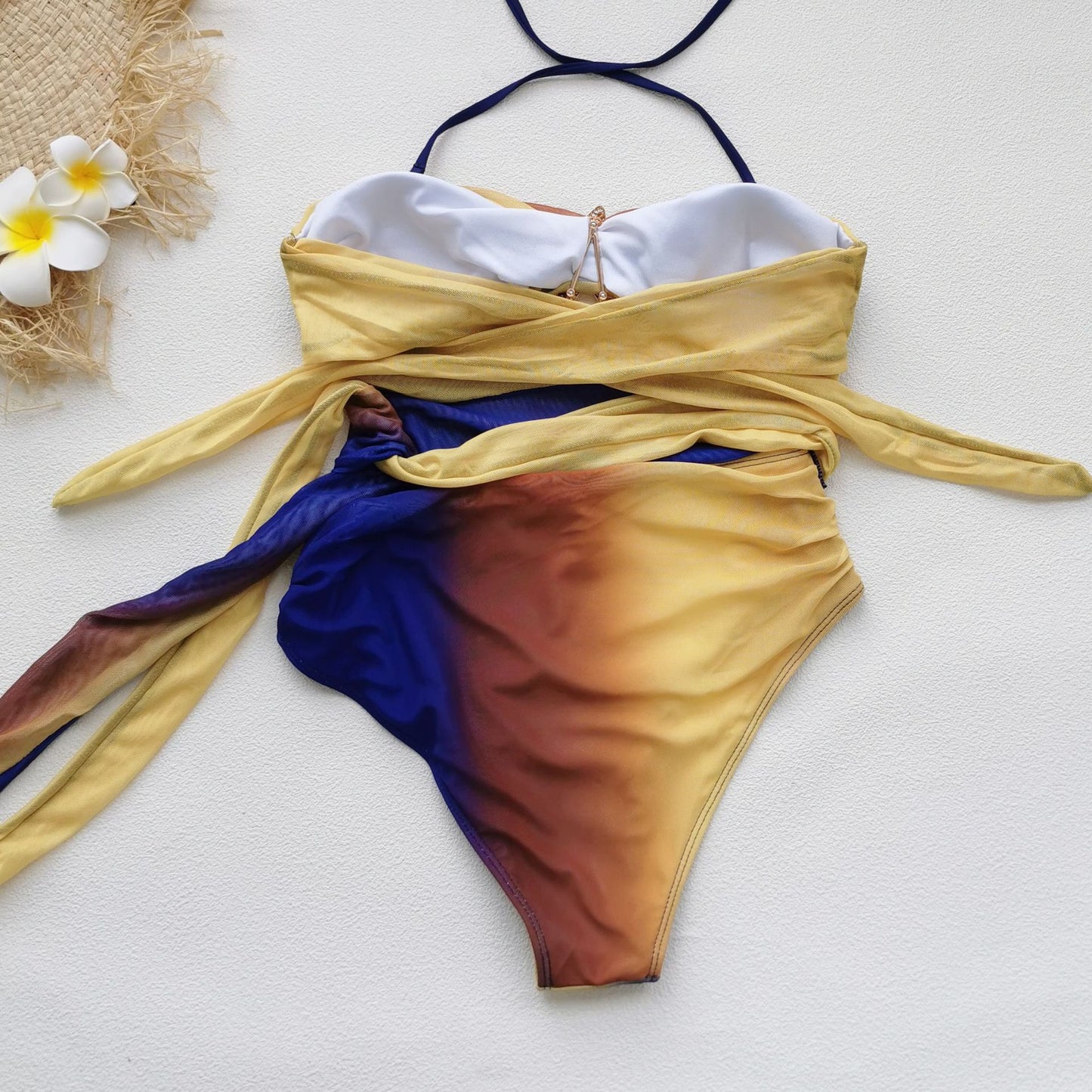 Colorful ombre dress with a halter neckline, a cutout midsection,and a high slit.