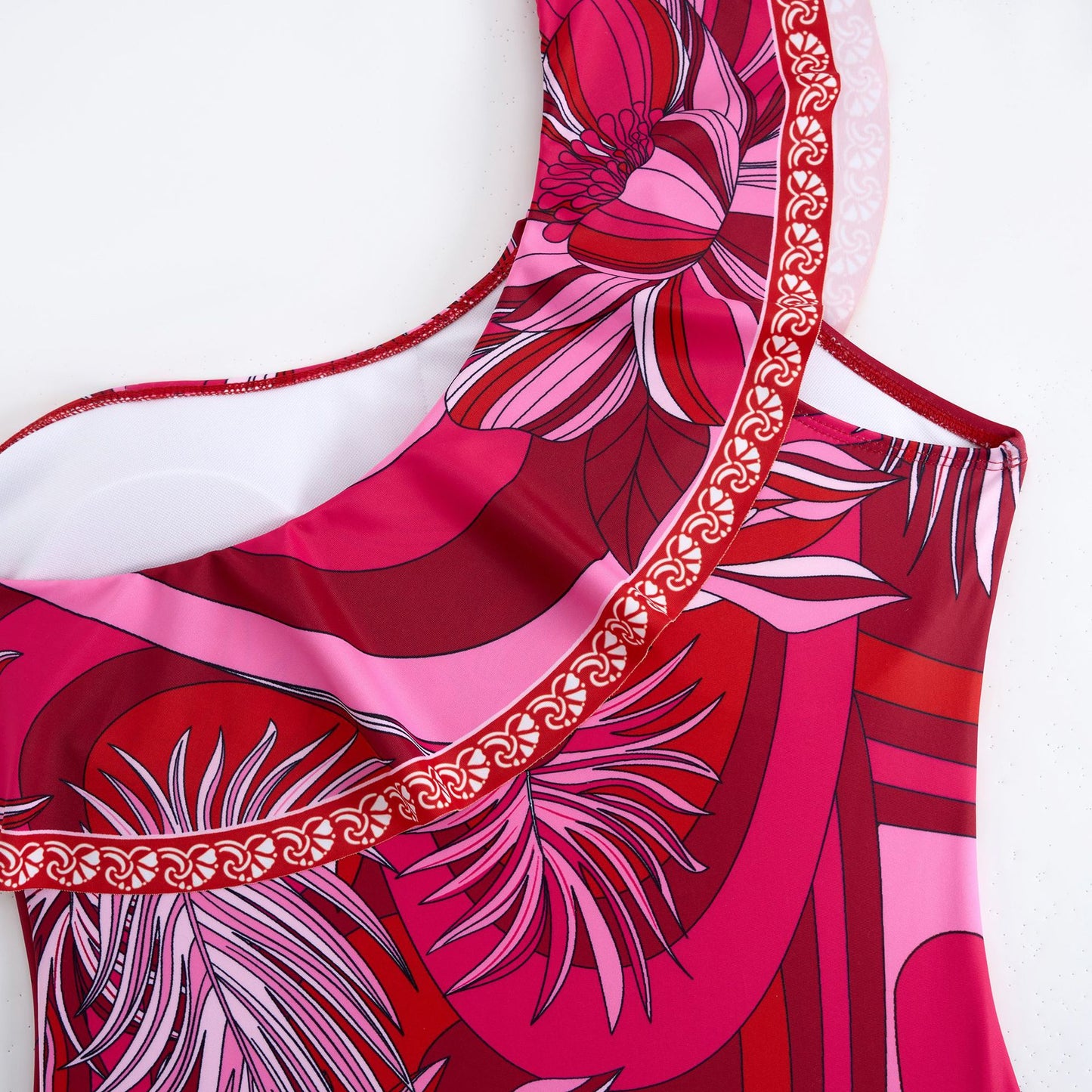 Red one-piece swimsuit with a single ruffled shoulder,paired with a matching short skirt