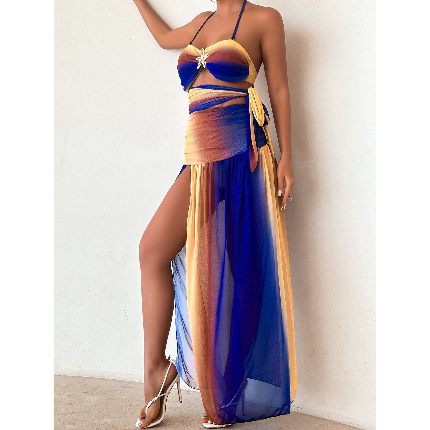 Colorful ombre dress with a halter neckline, a cutout midsection,and a high slit.