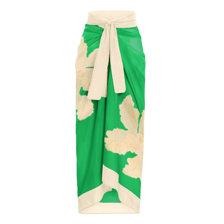Green and cream floral two-piece swimsuit with a tie-front top and a matching high-waisted wrap skirt.