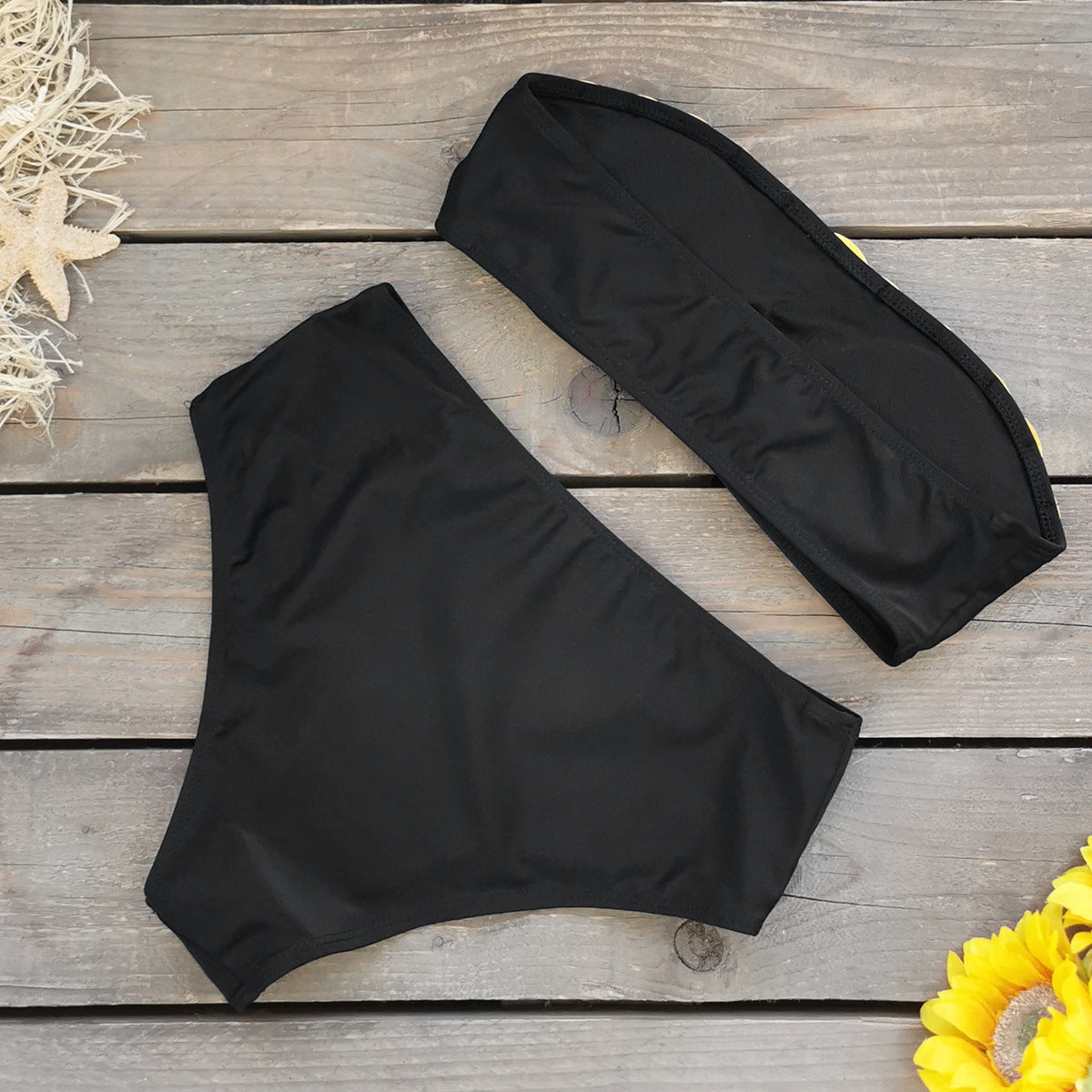 Black bandeau bikini top with a metallic gold stripe and high waisted black bikini bottoms.