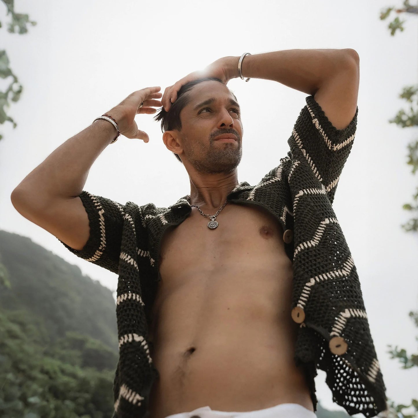 Black and white striped short sleeve shirt on a sandy beach