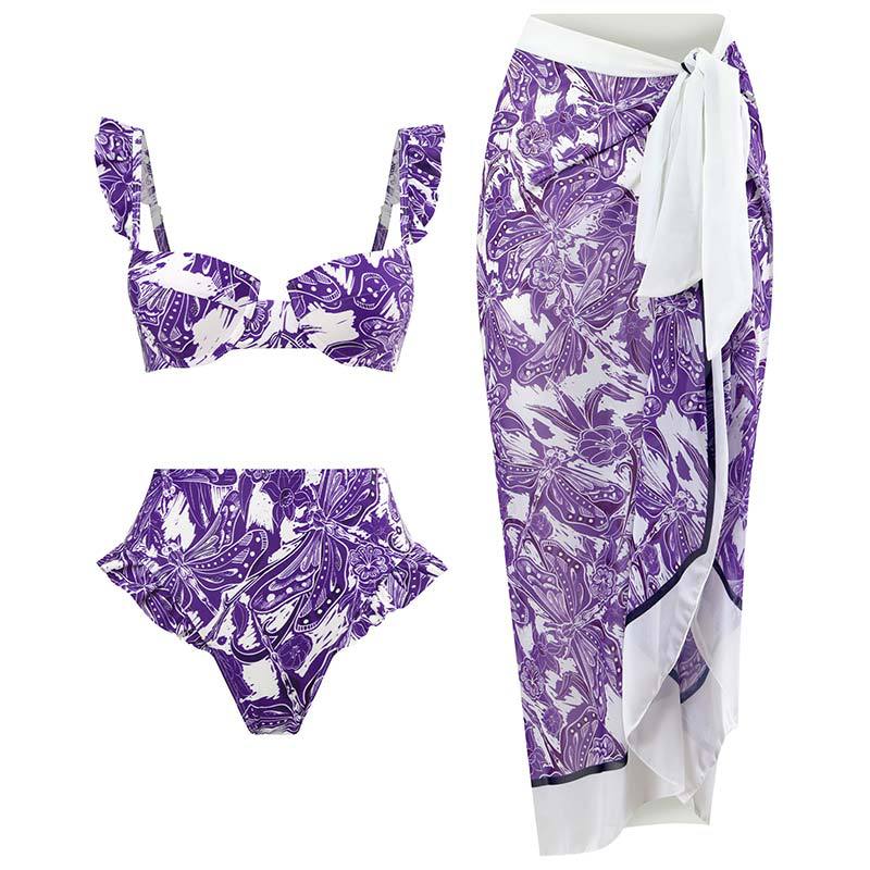 Bikini set featuring a purple and white floral print,paired with a matching wrap skirt.