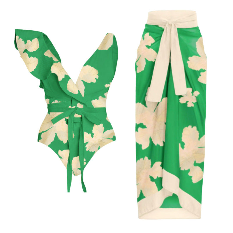 Green and cream floral two-piece swimsuit with a tie-front top and a matching high-waisted wrap skirt.