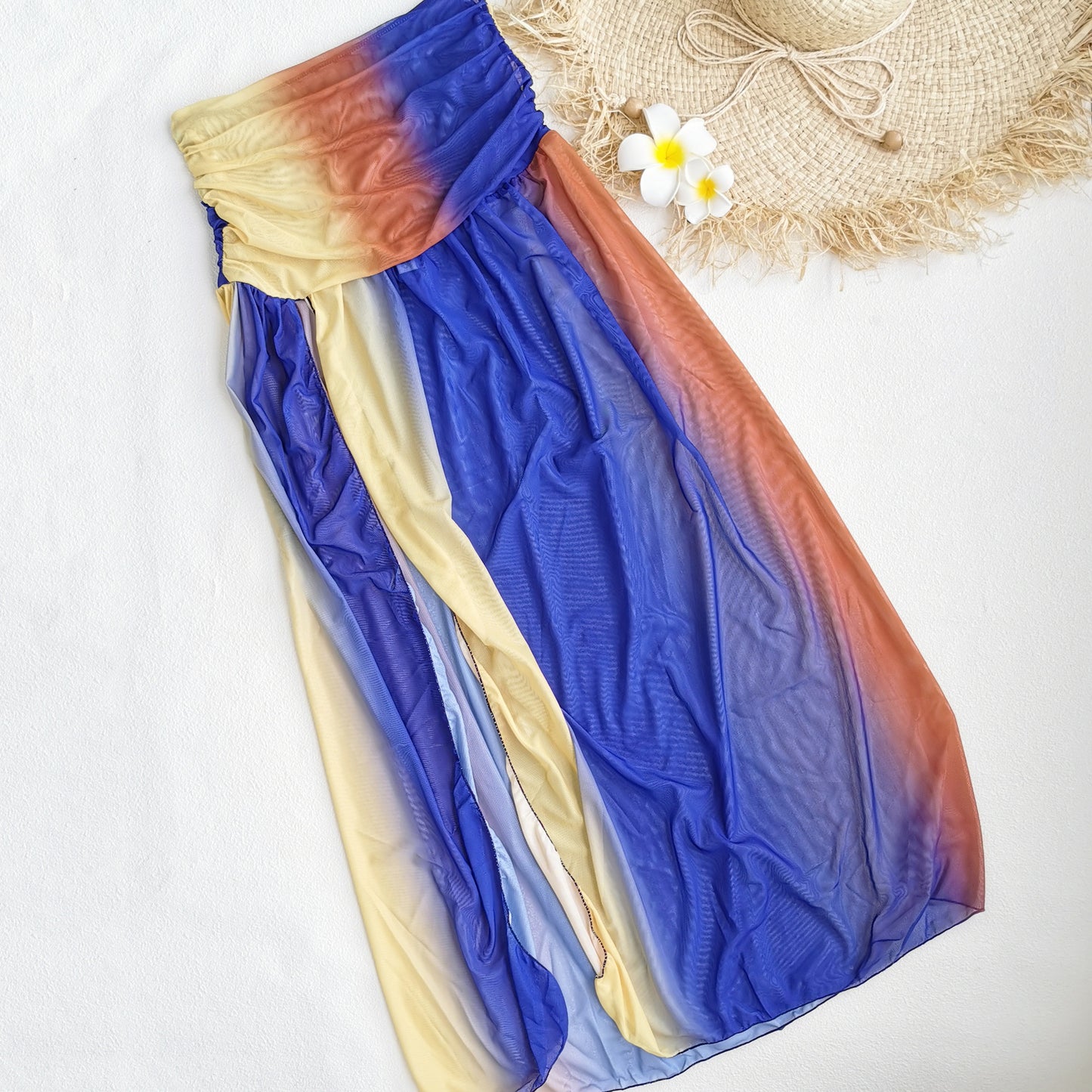 Colorful ombre dress with a halter neckline, a cutout midsection,and a high slit.